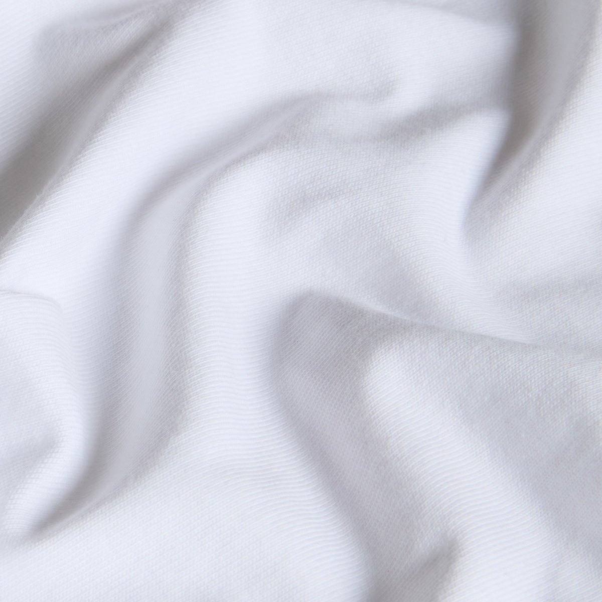 Pormenor da textura do jersey de algodão branco da t-shirt The North Face Off Piste Embro.
