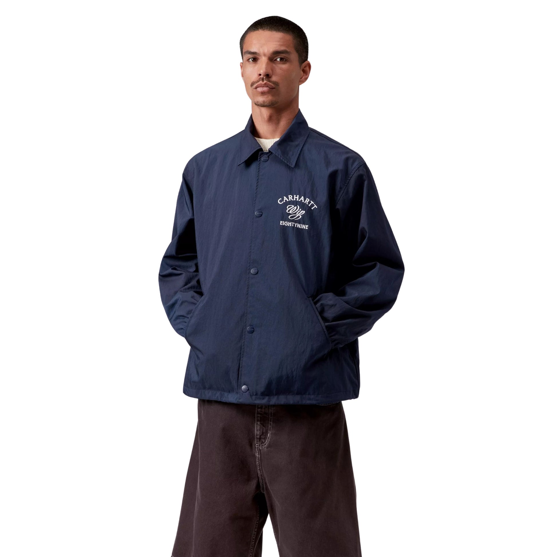 Casaco Coach para homem Carhartt WIP Eightynine em Jupiter/Branco. Foto da parte da frente, vestido.