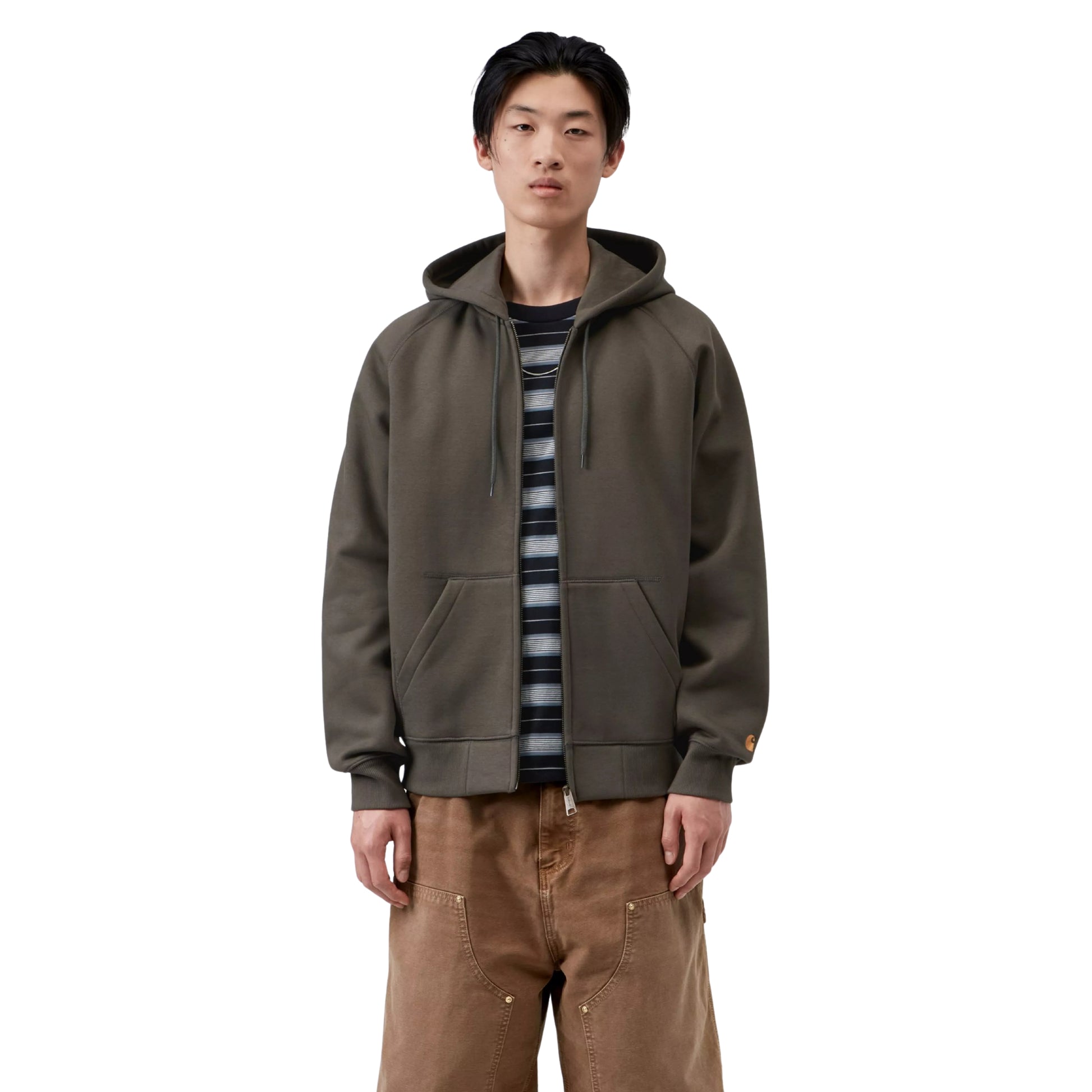 Casaco com carapuço Carhartt WIP Hooded Chase Jacket em Shungite / Gold — vista frontal com modelo, meio corpo, fecho aberto, logo "C" dourado na manga esquerda, combinado com t-shirt às riscas e calças cargo castanhas Carhartt WIP.