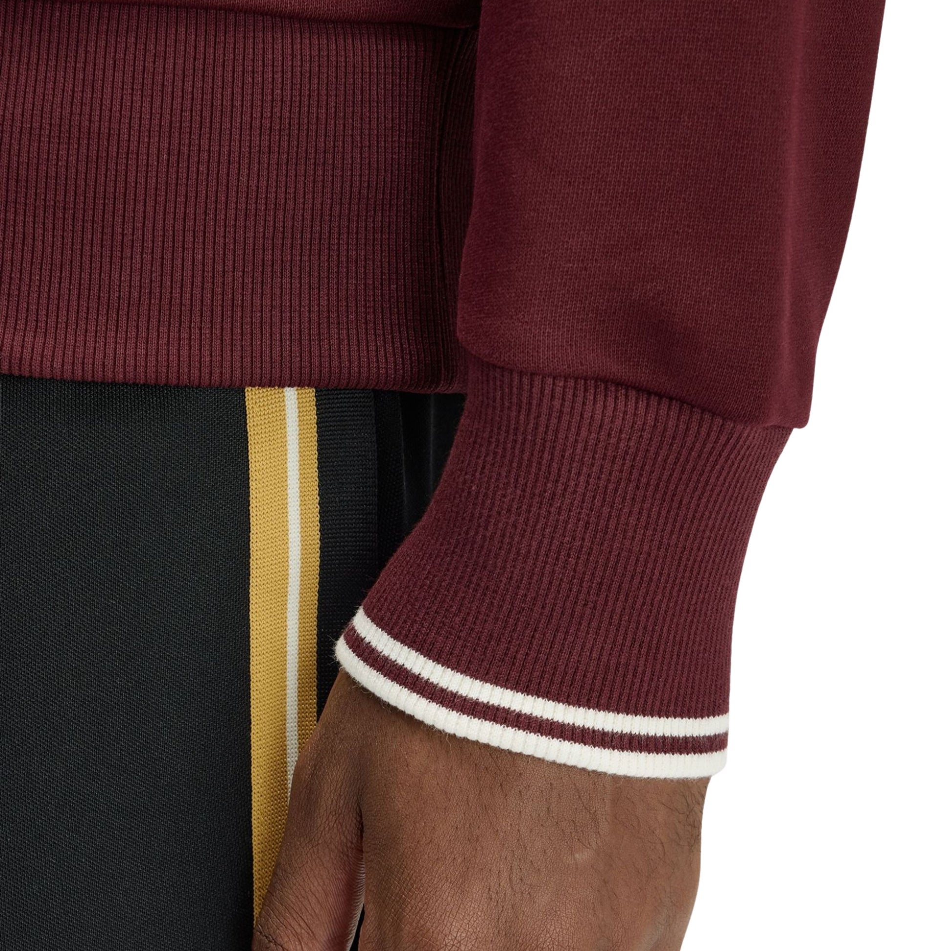 Sweat para homem Fred Perry Crew Neck em Oxblood/Ecru. Foto de detalhe da manga, vestida.