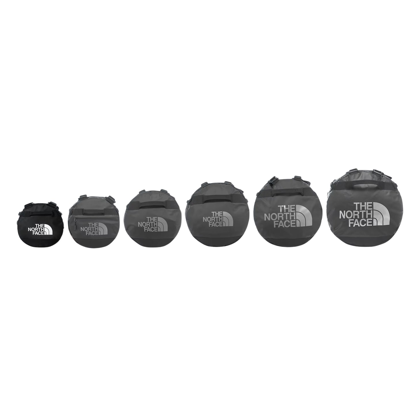 Comparação de tamanhos da gama The North Face Base Camp Duffel em TNF Black — 6 sacos alinhados por tamanho crescente da esquerda para a direita (XS ao XXL), logo TNF em branco no menor e em cinzento nos restantes, fundo branco.