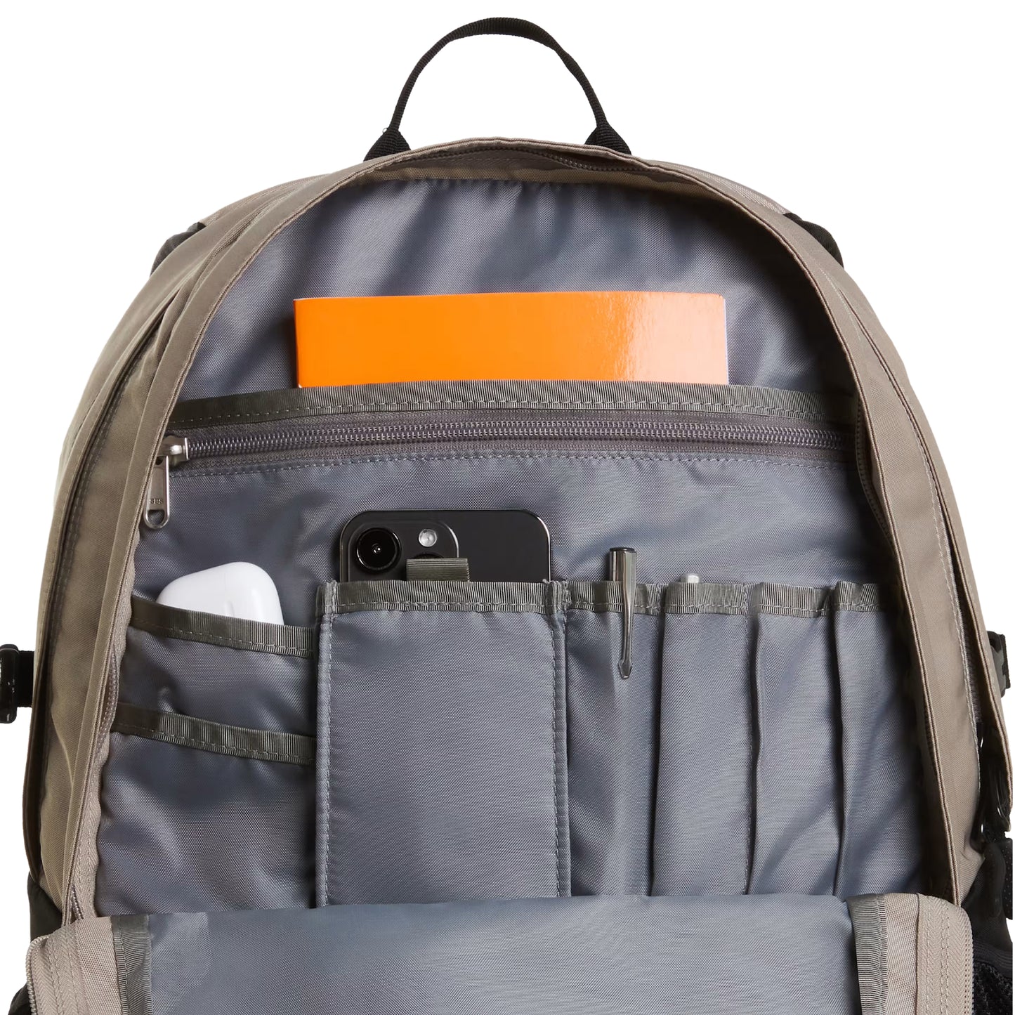 Mochila The North Face Borealis Classic Patch em Stone Slab / TNF Black — interior do bolso frontal aberto, com bolso para smartphone, porta-canetas e bolso zip interior cinzento com caderno laranja visíveis.