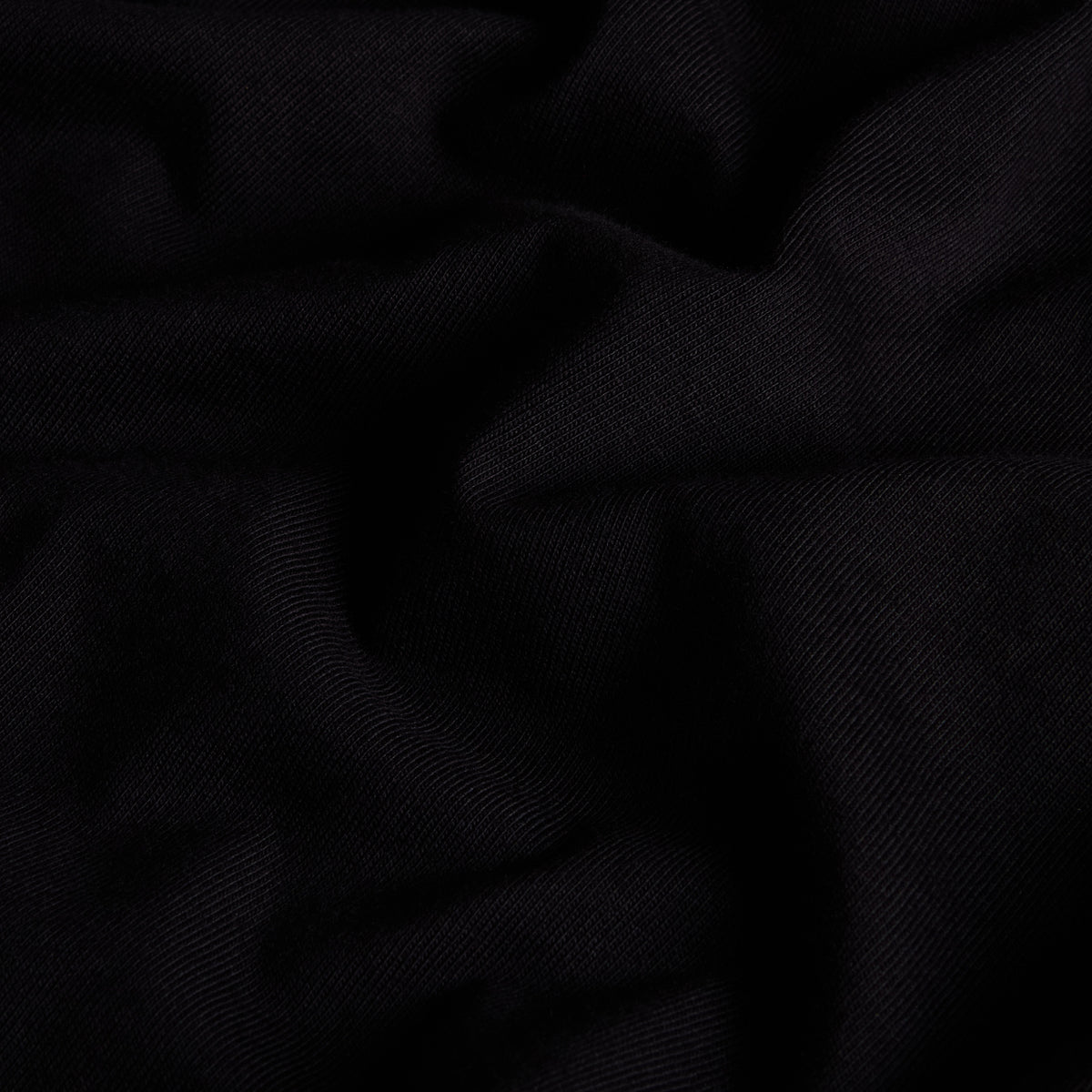 Pormenor da textura do jersey de algodão preto da t-shirt The North Face Off Piste Embro.