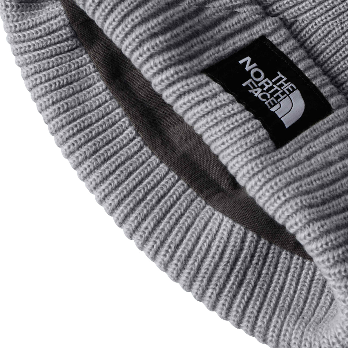 Pormenor do forro interior cinzento-escuro e da dobra em malha do gorro The North Face Salty Lined.