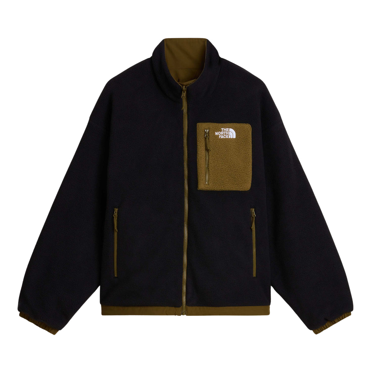 Vista frontal do lado polar preto do casaco The North Face Yumiori, com bolso de peito e acabamentos Caraway Seed.